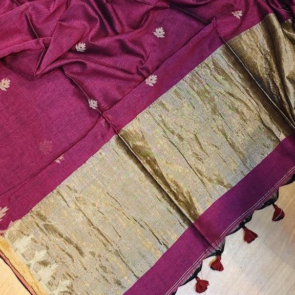 A deep magenta-purple cotton saree with small motifs